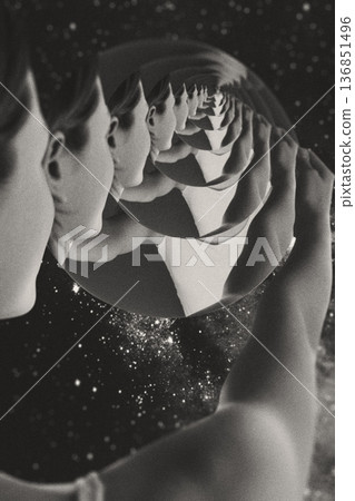 Person holding mirror reflecting infinite recursion in space Person holding mirror reflecting infinite recursion in space 136851496