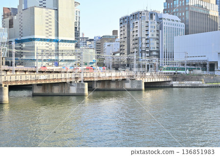 Keihan Electric Railway entering the underground track from the "portal" between the buildings Keihan Electric Railway entering the underground track from the "portal" between the buildings 136851983