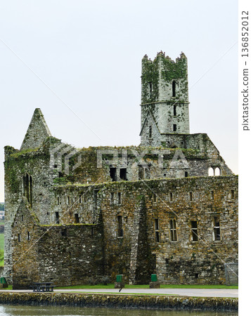 Timoleague Friary. Ancient stone monastery ruins. Historical Irish abbey. Old stone structure. Dramatic ruins of a religious building heritage. Timoleague Friary. Ancient stone monastery ruins. Historical Irish abbey. Old stone structure. Dramatic ruins of a religious building heritage. 136852012