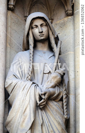 Saint Genevieve, statue on the portal of the Basilica of Saint Clotilde in Paris, France Saint Genevieve, statue on the portal of the Basilica of Saint Clotilde in Paris, France 136852062