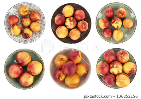 ripe nectarines and peaches served in various colorful ceramic plates and bowls. ripe nectarines and peaches served in various colorful ceramic plates and bowls. 136852150