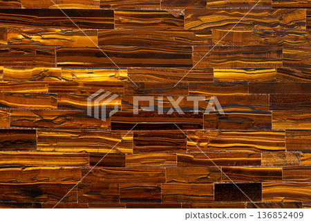 Tiger Eye Golden. Semi precious mineral pattern. Polished semiprecious stone for ceramic wall and floor digital tiles. Material for unique interior, exterior design. Luxury gemstone background. 136852409