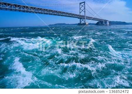 Springtime view of the Onaruto Bridge and whirlpools in the Naruto Strait in Tokushima Prefecture from a sightseeing boat Springtime view of the Onaruto Bridge and whirlpools in the Naruto Strait in Tokushima Prefecture from a sightseeing boat 136852472