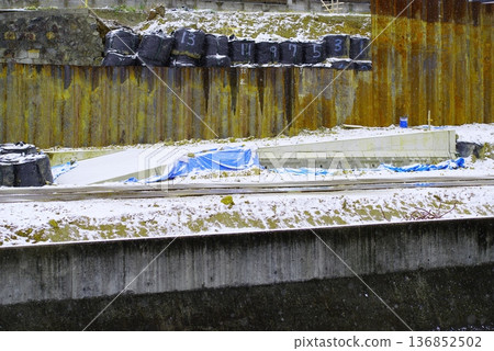 The inorganic landscape of a snow-covered construction site 136852502