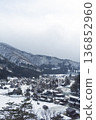Snowy scenery and mountain ranges of Shirakawa-go: Aerial view with white space in the sky 136852960