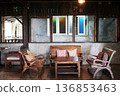 Brown wooden chairs and with sofa and table set on a wooden in vintage living room in Thailand 136853463