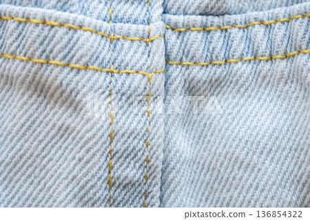 Old denim blue jeans fabric texture background close up 136854322