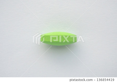 Green medicine pill tablet on white background Green medicine pill tablet on white background 136854419
