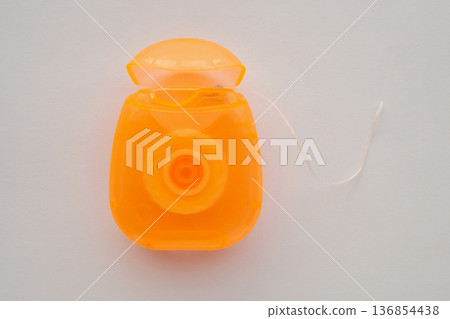 dental floss in case on white background 136854438