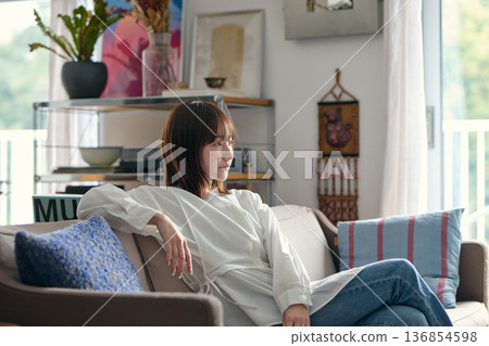 Woman watching TV on the sofa 136854598