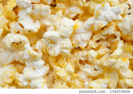 Tasty popcorn close up background top view Tasty popcorn close up background top view 136854689