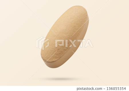 Orange vitamin pill tablet flying on background 136855354