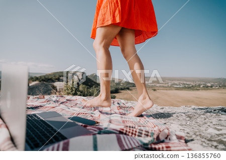 Barefoot Woman Walking Towards a Laptop on a Blanket Barefoot Woman Walking Towards a Laptop on a Blanket 136855760