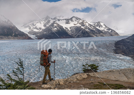Hiker walking ridge overlooking vast Grey Glacier, Torres del Paine, Chile 136856082
