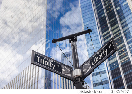 Trinity Place and Liberty Street signs at financial district intersection with modern skyscrapers in New York City USA Trinity Place and Liberty Street signs at financial district intersection with modern skyscrapers in New York City USA 136857607
