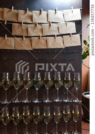 Champagne glasses lined up at a wedding reception 136857736
