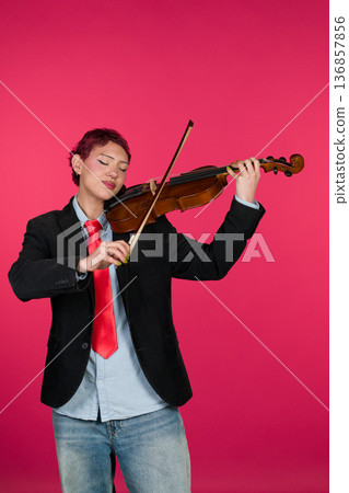 Individual playing violin with passion and focus 136857856
