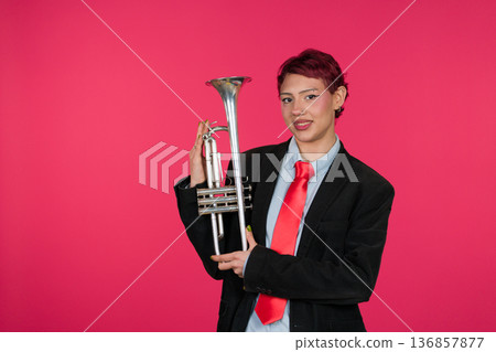 Confident musician holding trumpet looking at camera Confident musician holding trumpet looking at camera 136857877