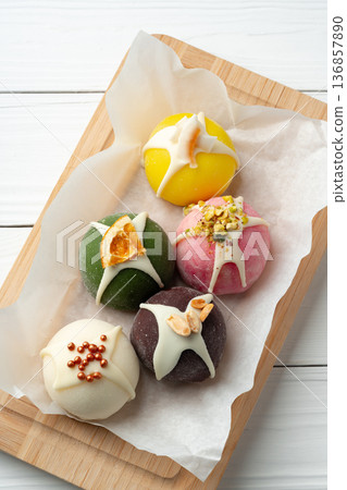Colorful sweets on a wooden tray with different flavors and toppings in a bright setting Colorful sweets on a wooden tray with different flavors and toppings in a bright setting 136857890