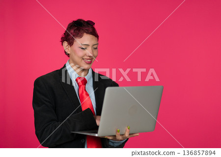 Young identifying person smiling working on laptop Young identifying person smiling working on laptop 136857894