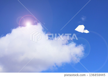 Paper plane flying in the sky 136858445