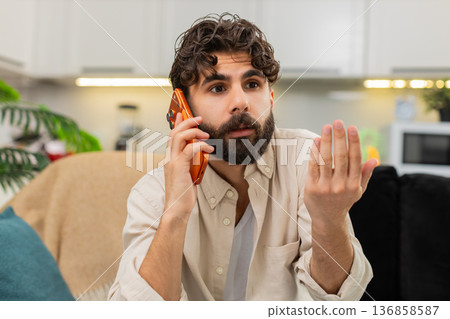 Indian man smartphone night spam call angry tired user ending conversation hangs up frustrated quick Indian man smartphone night spam call angry tired user ending conversation hangs up frustrated quick 136858587