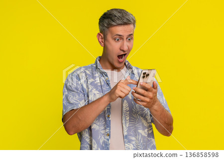 Man scrolling smartphone suddenly shocked with wide eyes open mouth surprised by unexpected news Man scrolling smartphone suddenly shocked with wide eyes open mouth surprised by unexpected news 136858598