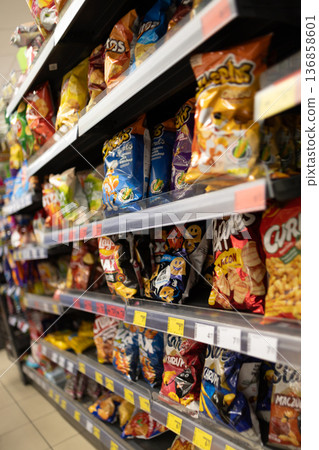 Snack display in a store with various chip brands and flavors Snack display in a store with various chip brands and flavors 136858601