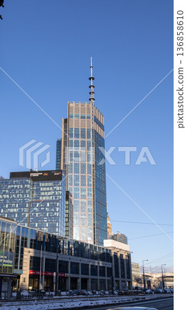 Modern building stands tall against blue sky in city center during day 136858610