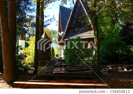 Beautiful wooden structure surrounded by trees in a peaceful garden setting Beautiful wooden structure surrounded by trees in a peaceful garden setting 136858612