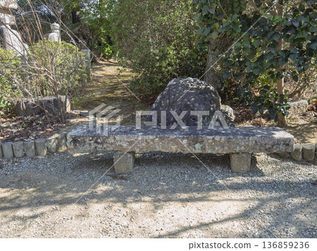 A stone bench that marks the passage of time, a place to rest in a tranquil garden A stone bench that marks the passage of time, a place to rest in a tranquil garden 136859236