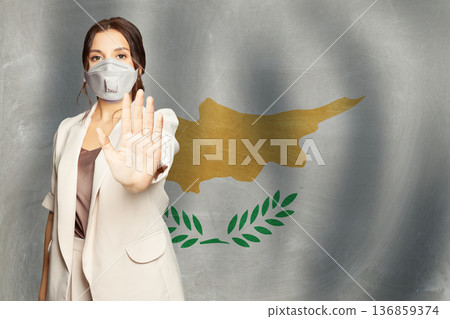 Confident woman in medical mask showing stop gesture open palm hand against Cyprus background Confident woman in medical mask showing stop gesture open palm hand against Cyprus background 136859374