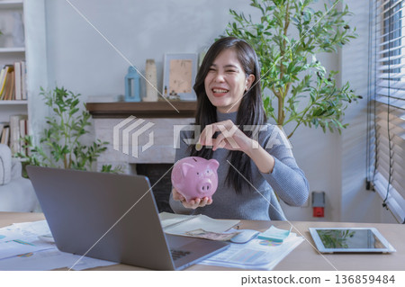 Business woman or accountant working on calculator to calculate business data in modern office. Business woman or accountant working on calculator to calculate business data in modern office. 136859484