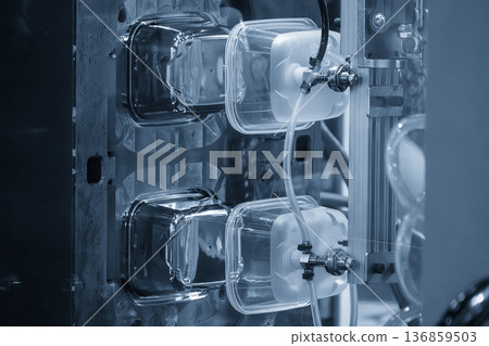 Automated mass production of food-grade plastic containers using an advanced injection molding machine integrated with a 6-axis robotic arm. Automated mass production of food-grade plastic containers using an advanced injection molding machine integrated with a 6-axis robotic arm. 136859503