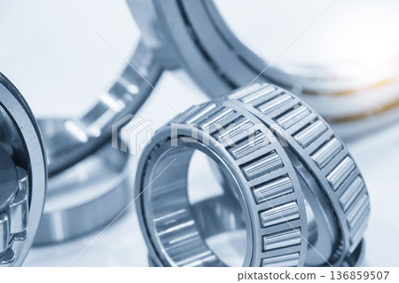 Group of high-precision tapered roller bearings designed for combined radial and axial load distribution in industrial applications. Group of high-precision tapered roller bearings designed for combined radial and axial load distribution in industrial applications. 136859507