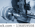 Precision CNC lathe machine performing high-speed cutting on a high-grade metal mold component for plastic bottle production. 136859508