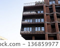 Building features balconies and windows in a city during daylight hours 136859977