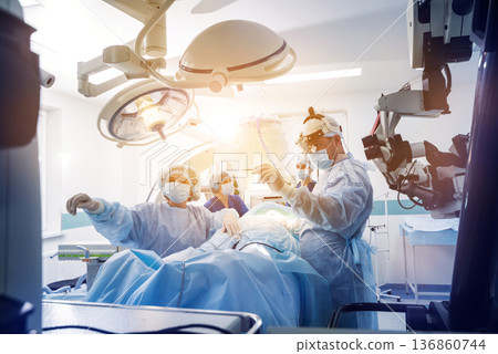 Spinal surgery. Group of surgeons in operating room with surgery equipment. Spinal surgery. Group of surgeons in operating room with surgery equipment. 136860744