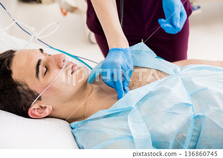 Doctors give resuscitation to a male patient in the emergency room. 136860745