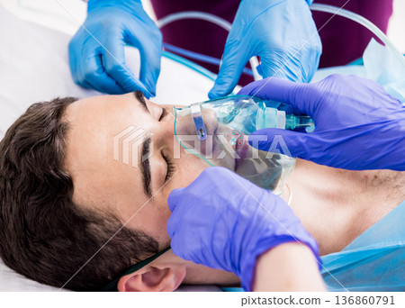 Doctors give resuscitation to a male patient in the emergency room. Doctors give resuscitation to a male patient in the emergency room. 136860791
