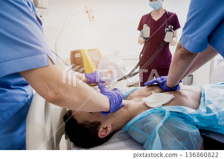 Doctors give resuscitation to a male patient in the emergency room. Doctors give resuscitation to a male patient in the emergency room. 136860822