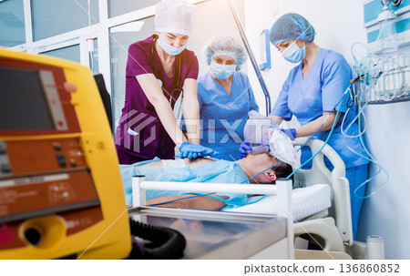 Doctors give resuscitation to a male patient in the emergency room. Doctors give resuscitation to a male patient in the emergency room. 136860852