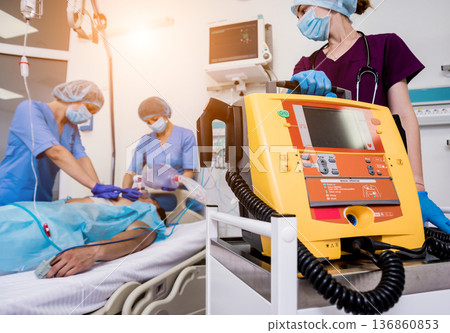 Doctors give resuscitation to a male patient in the emergency room. 136860853