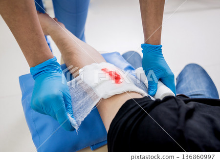 Nurse dressing wound for patient's hand with deep skin cutting. Nurse dressing wound for patient's hand with deep skin cutting. 136860997