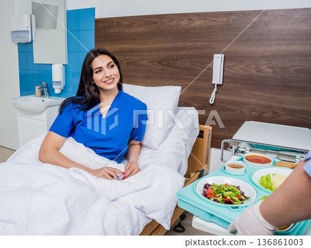 Nurse in medical coat is holding a tray with breakfast Nurse in medical coat is holding a tray with breakfast 136861003