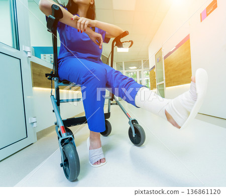 Patient on rollator with hand brakes moving in hospital Patient on rollator with hand brakes moving in hospital 136861120