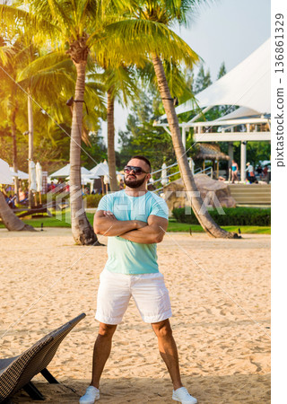 Young man on a tropical beach. Summer Young man on a tropical beach. Summer 136861329