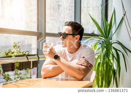 Young man in the pub. Drinking beer, eating pizza. Young man in the pub. Drinking beer, eating pizza. 136861371