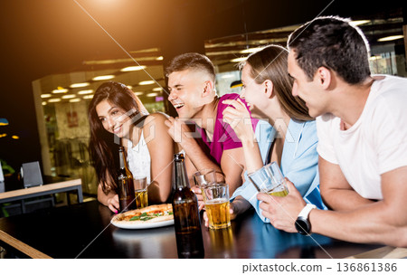 Cheerful friends in the pub. Drinking beer, wine and whisky Cheerful friends in the pub. Drinking beer, wine and whisky 136861386