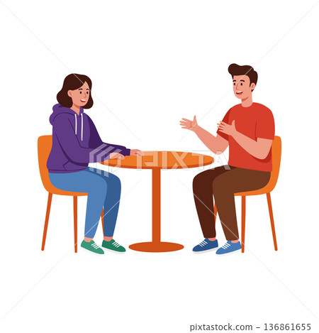 Two people having a friendly conversation sitting at a round table indoors casual clothing lifestyle scene 136861655